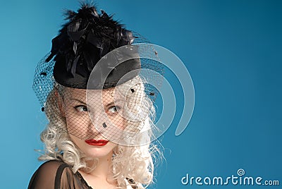Gorgeous retro girl in forties hat with feathers Stock Photo