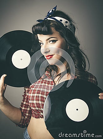 Gorgeous retro pin up girl posing with records Stock Photo