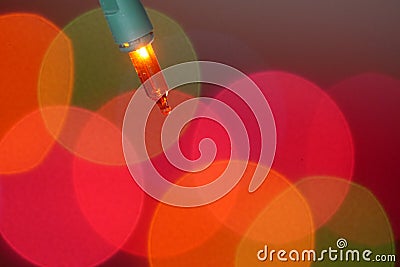 Gorgeous shot of Orange Christmas tree lightbulb Stock Photo