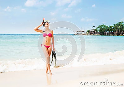 Gorgeous, slim, cheerful girl posing with diving mask and flippers on the seacoast in Thailand Stock Photo