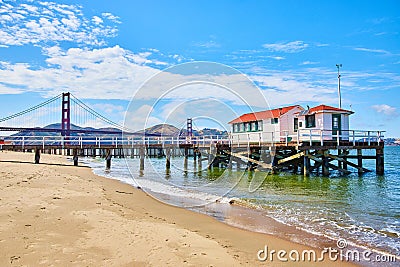 Gorgeous summer day on San Francisco Bay with beach and pier in front of Golden Gate Bridge Editorial Stock Photo