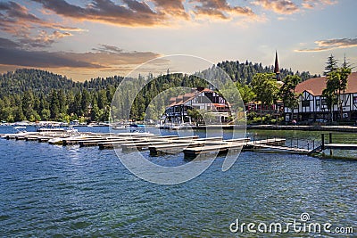 A gorgeous summer landscape at Lake Arrowhead village with boats and yachts sailing on the rippling blue later water, homes Editorial Stock Photo