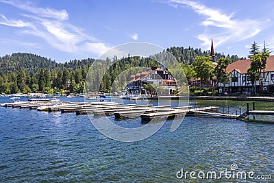 A gorgeous summer landscape at Lake Arrowhead village with boats and yachts sailing on the rippling blue later water, homes Editorial Stock Photo