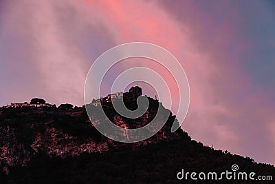 Gorgeous sundown at Amalfy coast, Italy with magnificent luminous colors over mountain with cross Editorial Stock Photo