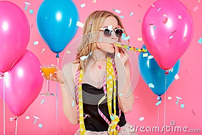 Gorgeous trendy young woman in party outfit celebrating birthday. Party mood, balloons, flying confetti, cocktail and dancing. Stock Photo