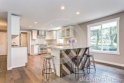 Gorgeous white kitchen with bar style island. Stock Photo