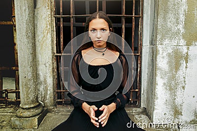 Gorgeous women in black sitting at old church and posing, stylish gothic themed, ladies party. witch look, mystery atmospheric Stock Photo