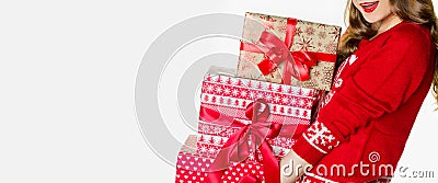 Gorgeous woman in christmas jumper holding loads of heavy xmas presents, christmas banner, isolated Stock Photo