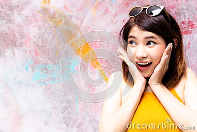 Gorgeous woman is looking at copy space. Charming beautiful woman acts like a surprise, happy, shock, admire or wow some goods, p Stock Photo