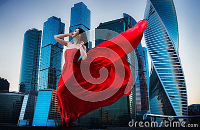 Gorgeous woman in red fluttered dress. Freedom concept. Fashion Stock Photo
