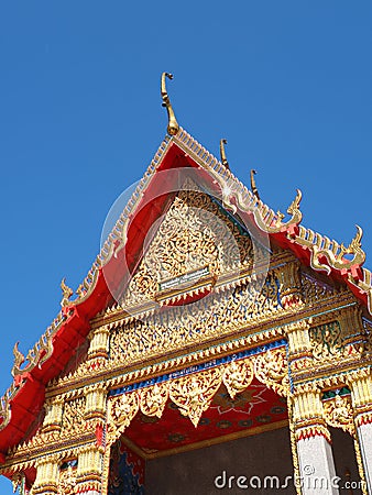 Gorgeously crafted temple gable soaring into blue sky Stock Photo