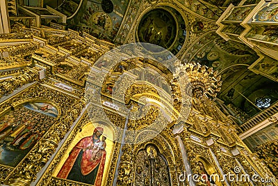 Gorgeously decorated altar and frescoes on walls in the interior of Holy Dormition Cathedral in Pechersk Lavra, Kyiv Stock Photo