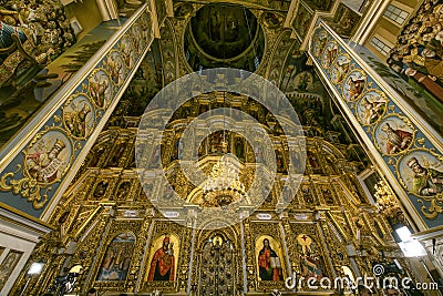 Gorgeously decorated altar and frescoes on walls in the interior of Holy Dormition Cathedral in Pechersk Lavra, Kyiv Stock Photo
