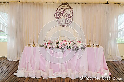 Gorgeously decorated newlyweds table with monogram under it Stock Photo