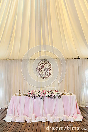 Gorgeously decorated newlyweds table with monogram under it Stock Photo