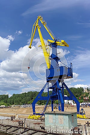 Gorodets, Russia. - June 2.2016. Blue portal crane with a yellow arrow on the cargo wharf in Gorodets about Gateway. Editorial Stock Photo