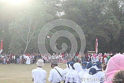 The Indonesian flag lowering ceremony witnessed by villagers. Indonesia Independence Day Editorial Stock Photo