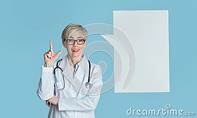 Got an idea and doctor advice. Woman in white coat points finger up, near abstract place for thought Stock Photo