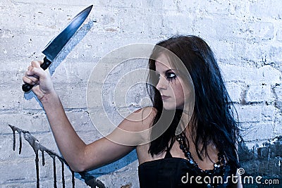 Goth girl holding a knife Stock Photo