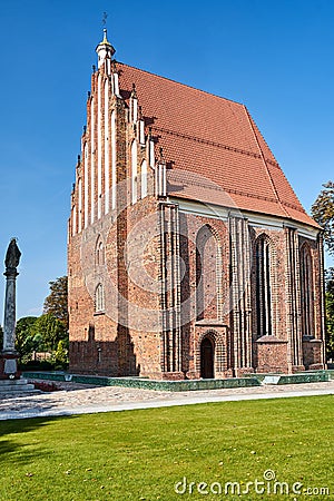 Gothic brick chapel and statue on a column i Stock Photo