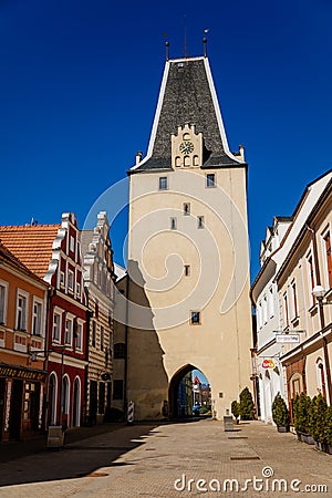 Gothic clock tower Mikulov Gate, Narrow picturesque street with colorful renaissance and baroque buildings in historic center in Editorial Stock Photo