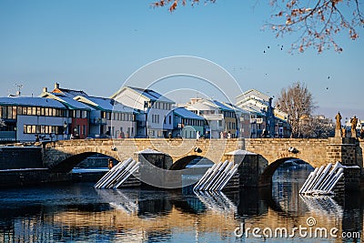 Gothic medieval Stony Deer bridge with show Riverbank of the Otava river in winter sunny day the oldest bridge in historical Editorial Stock Photo
