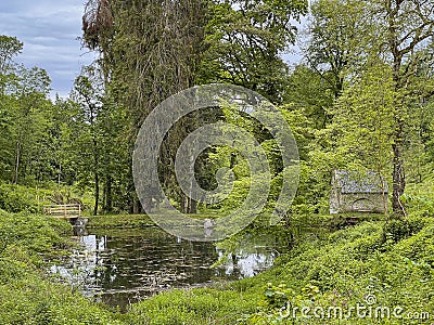 Gothic pumphouse and pond Stock Photo