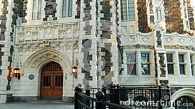 Gothic styled building structure gated double entry lights wooden doors Stock Photo