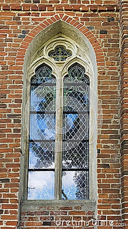 Gothic window in a small country church, Gothic red brick architecture in the Baltics Stock Photo