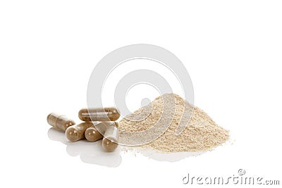 Gotu kola gel capsules and heap of powder. Stock Photo