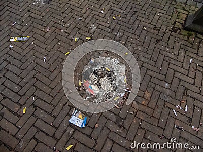 Gouda, South Holland/The Netherlands - January 1 2020: burned small pile of ashes and firework remains Editorial Stock Photo