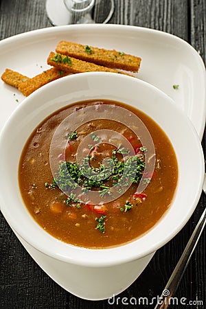 Goulash soup with beans, bell peppers and garlic croutons. Top v Stock Photo