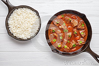 Goulash traditional Hungarian beef meat stew soup food cooked recipe with spicy gravy sauce in cast iron pan Stock Photo