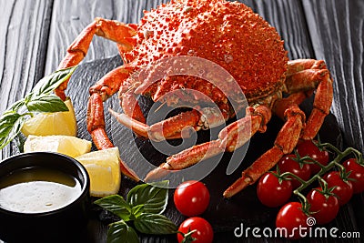 Gourmet boiled whole spider crab with lemon, tomatoes, bisillic Stock Photo