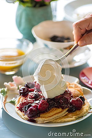 Gourmet breakfast of pancakes, fruit puree and whip cream Stock Photo