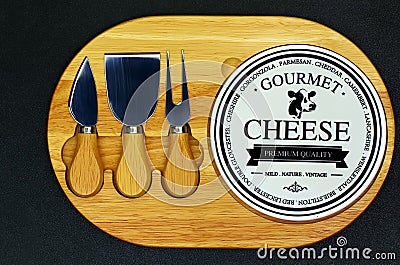 Gourmet cheese cutting board with knives Editorial Stock Photo