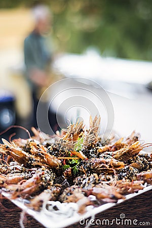 Gourmet kampot pepper sauce prawns in modern outdoor bar Stock Photo