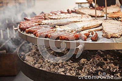 Gourmet meat pieces pork ribs, sausages, on a large grill . Stock Photo
