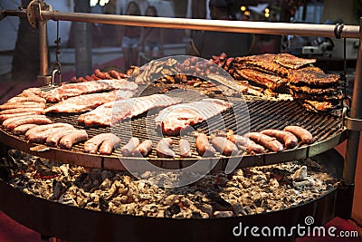 Gourmet meat pieces pork ribs, sausages, on a large grill . Stock Photo