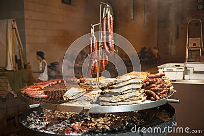 Gourmet meat pieces pork ribs, sausages, on a large grill . Stock Photo