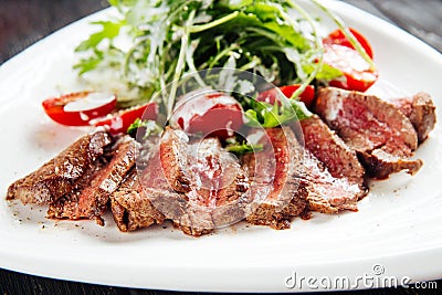 Gourmet roast beef with arugula and tomato salad Stock Photo