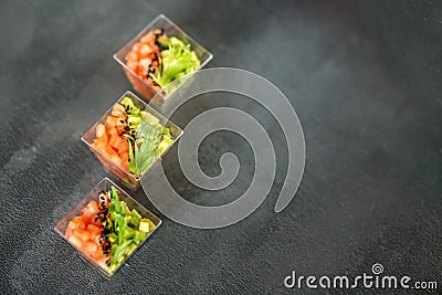 Gourmet salad with avocado and tomatoes on a gray background. Top view. Concept for food, diet and healthy food, restaurant and Stock Photo