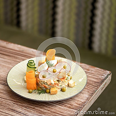 Gourmet salad from fresh vegetables with mayonnaise and croutons decorated with radish slices. Festive dish, nicely Stock Photo