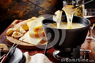 Gourmet Swiss fondue dinner on a winter evening Stock Photo