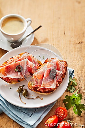 Gourmet tostada snacks with prosciutto ham Stock Photo