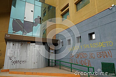 Government building with broken windows vandalized by protesters in Punta Arenas, Chile Editorial Stock Photo