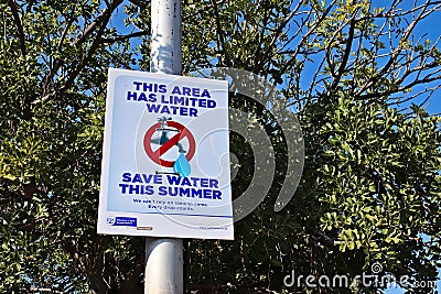 A government signpost which encourages citizens to save water in the town. Editorial Stock Photo