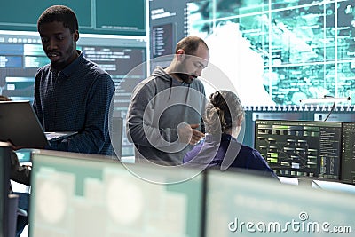 Governmental hackers working on computer network in high tech office Stock Photo