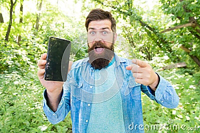 GPS and navigation apps. Useful program. Smartphone online navigation. Man bearded wanderer walking in forest with Stock Photo