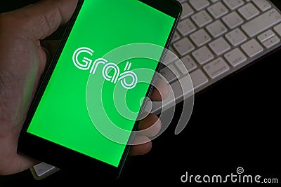 GRAB FOOD services apps text on mobile phone Editorial Stock Photo